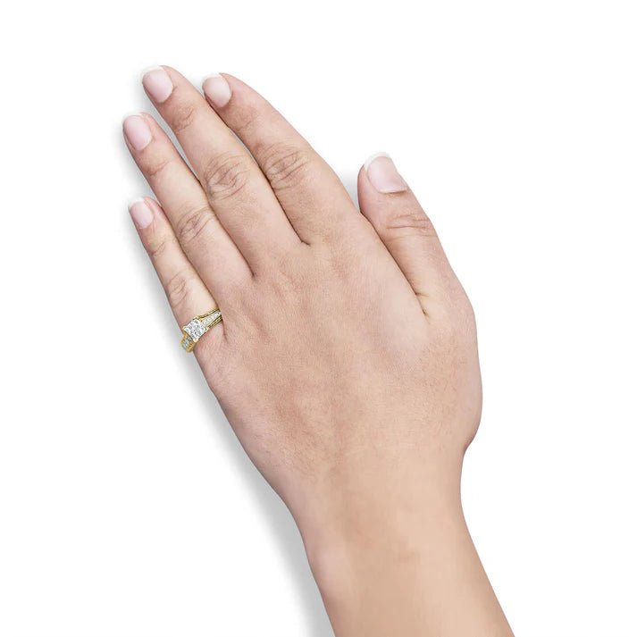 Hand wearing a gold ring with a diamond on a white background