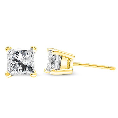 Gold stud earrings with clear gemstones on a white background