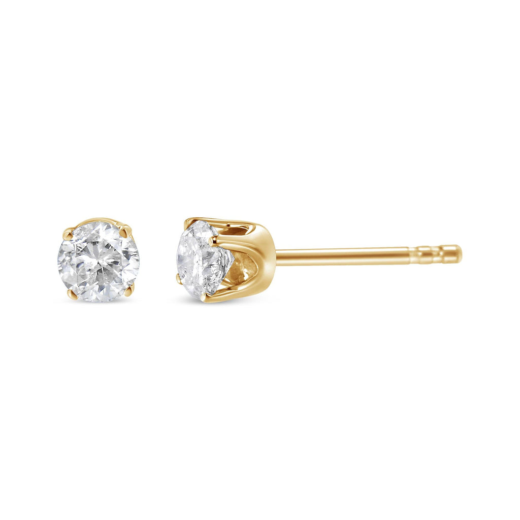 Gold stud earrings with clear gemstones on a white background