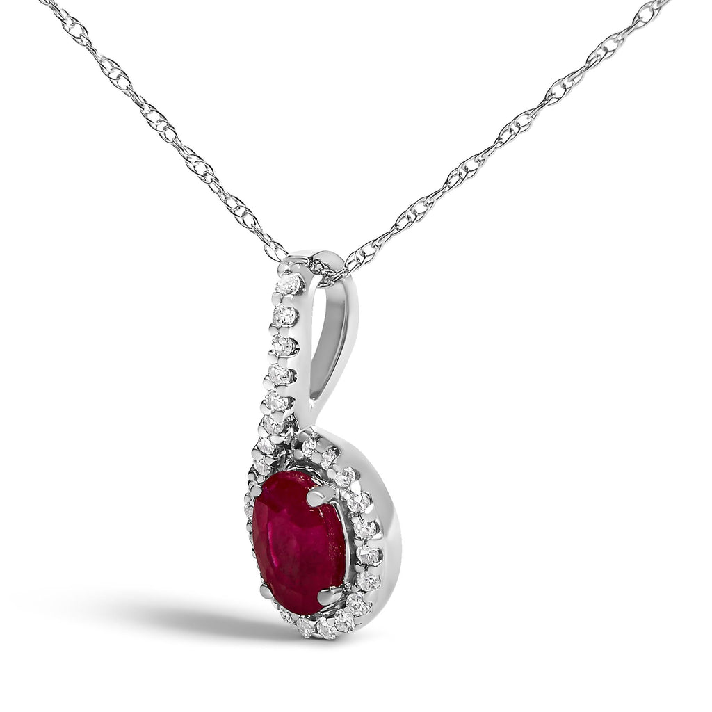 Silver pendant with a red gemstone and diamonds on a white background
