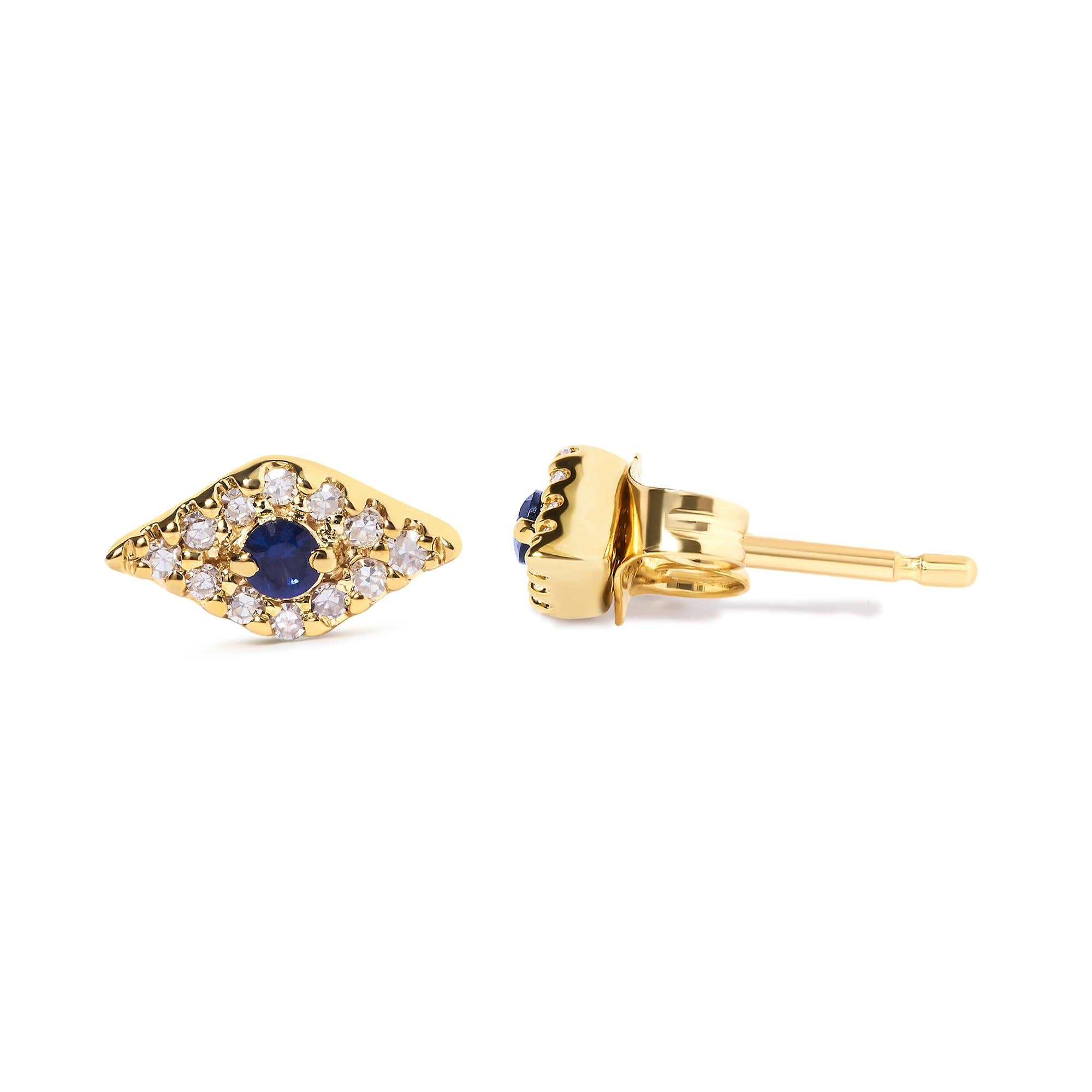 Gold earrings with blue gemstones and clear stones on a white background