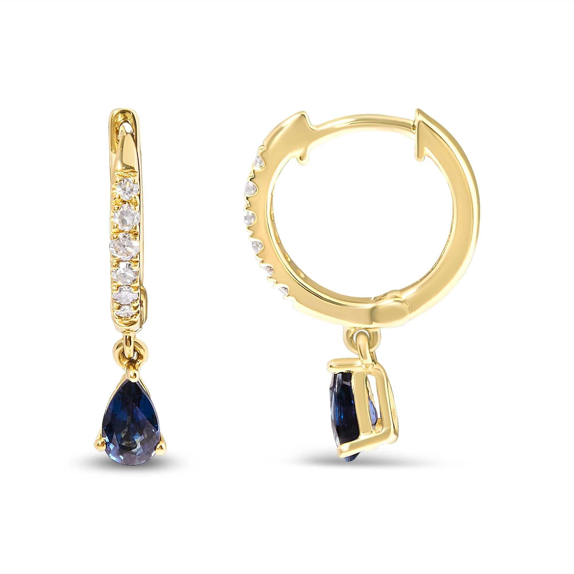Gold hoop earrings with blue gemstones on a white background