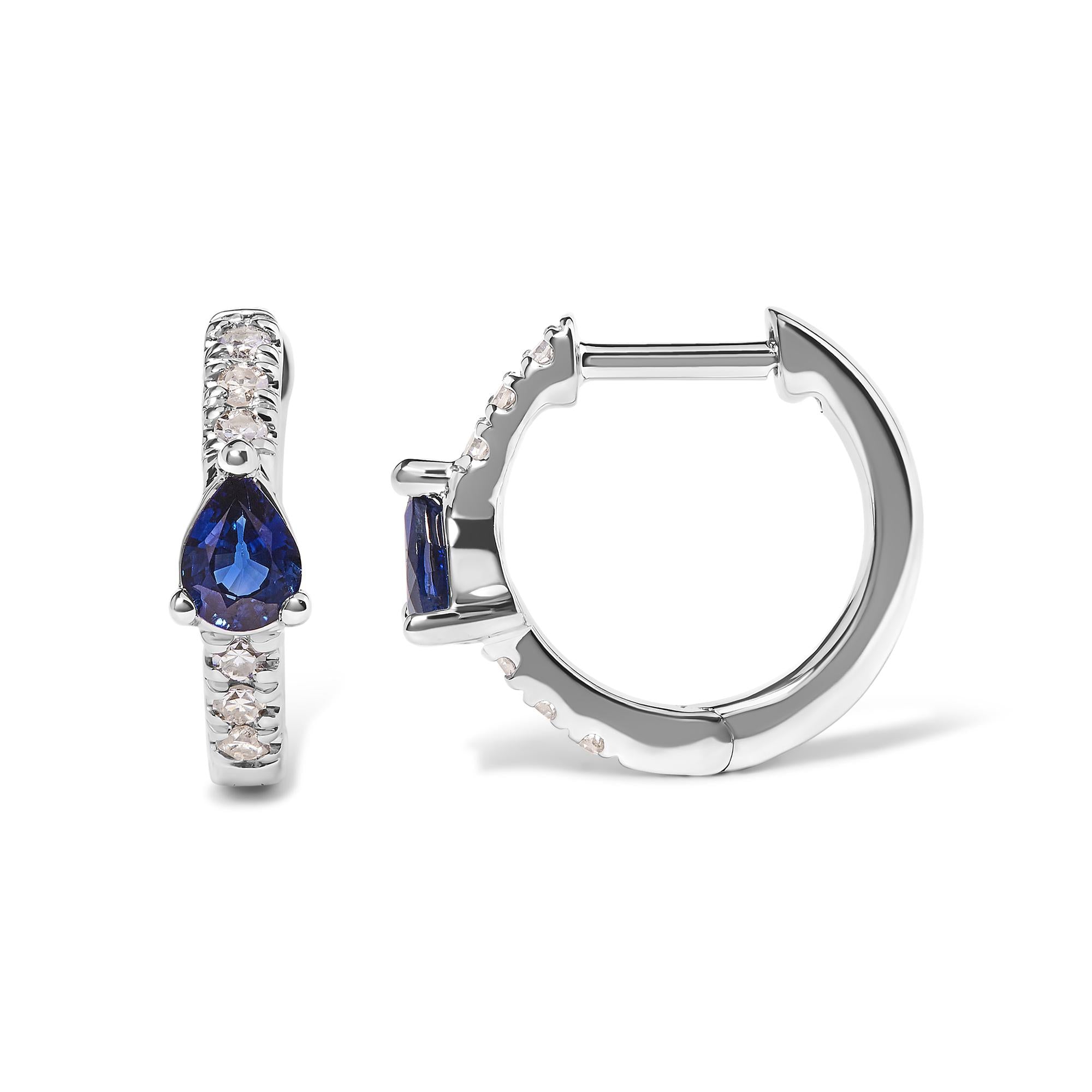 Silver hoop earrings with blue gemstones on a white background