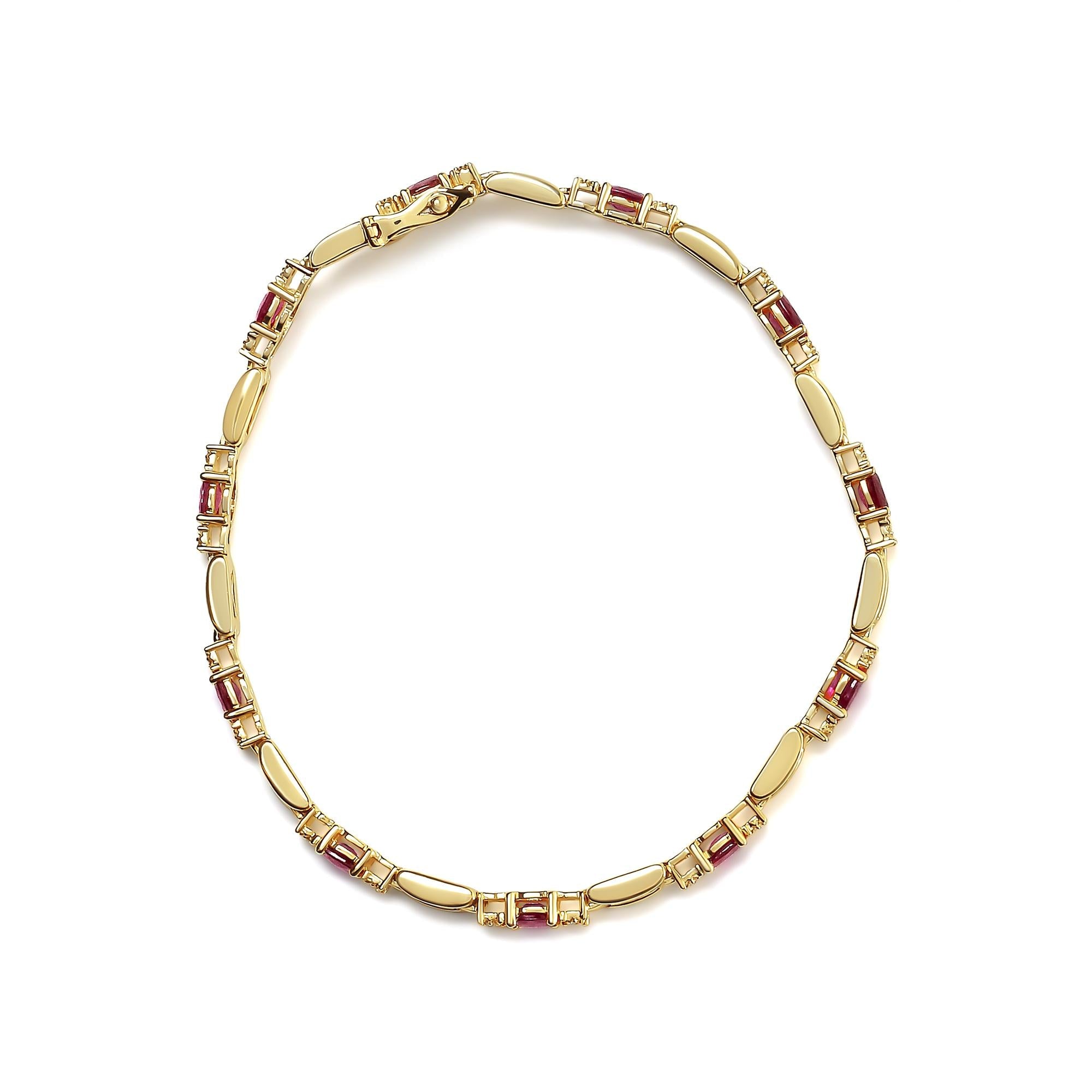 Gold bracelet with embedded red stones on a white background