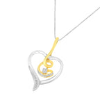 Two-tone heart-shaped pendant with a diamond on a white background