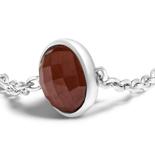 Silver bracelet with a brown gemstone on a white background