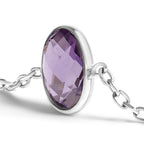Silver bracelet with a purple gemstone on a white background