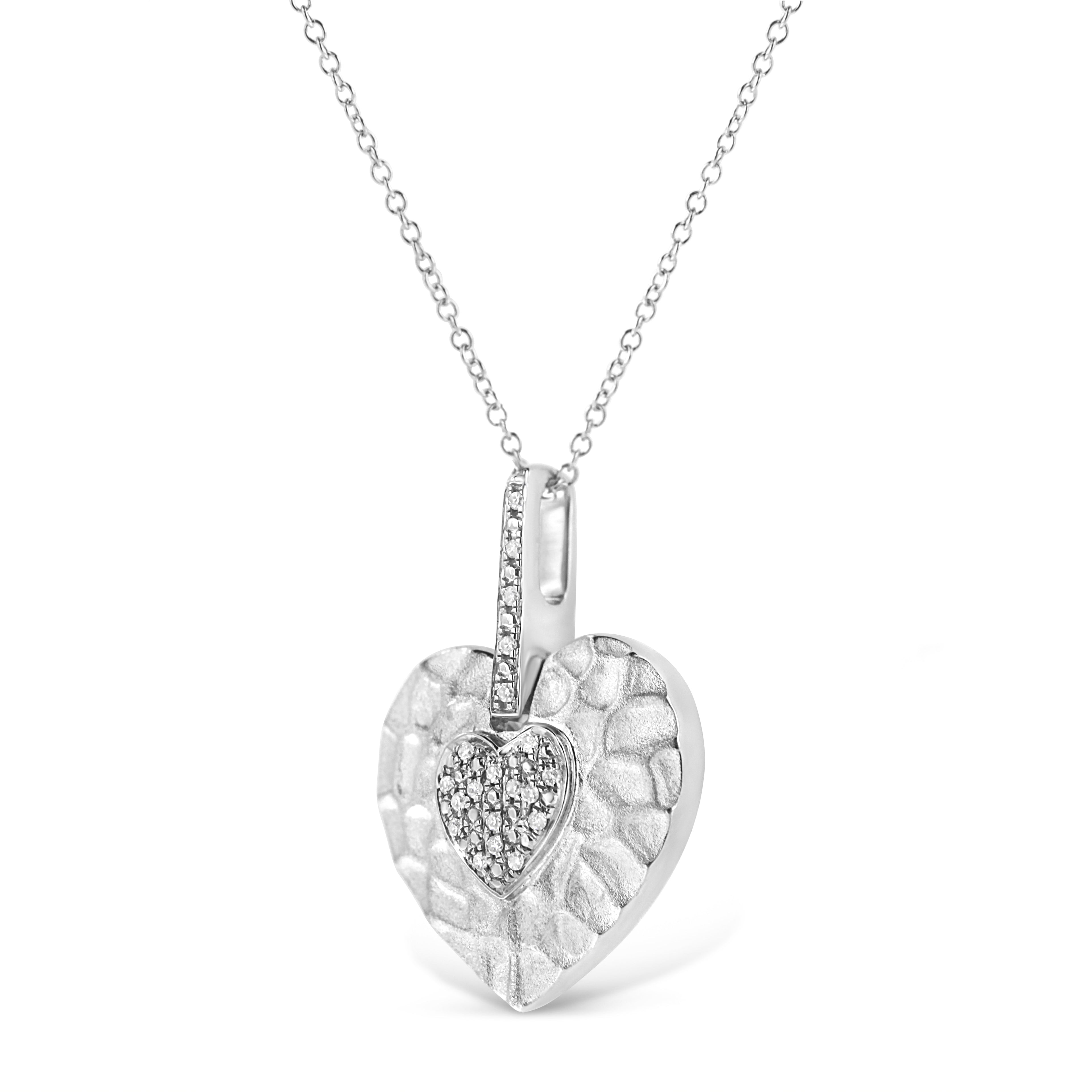 Heart-shaped silver pendant with diamond accents on a white background