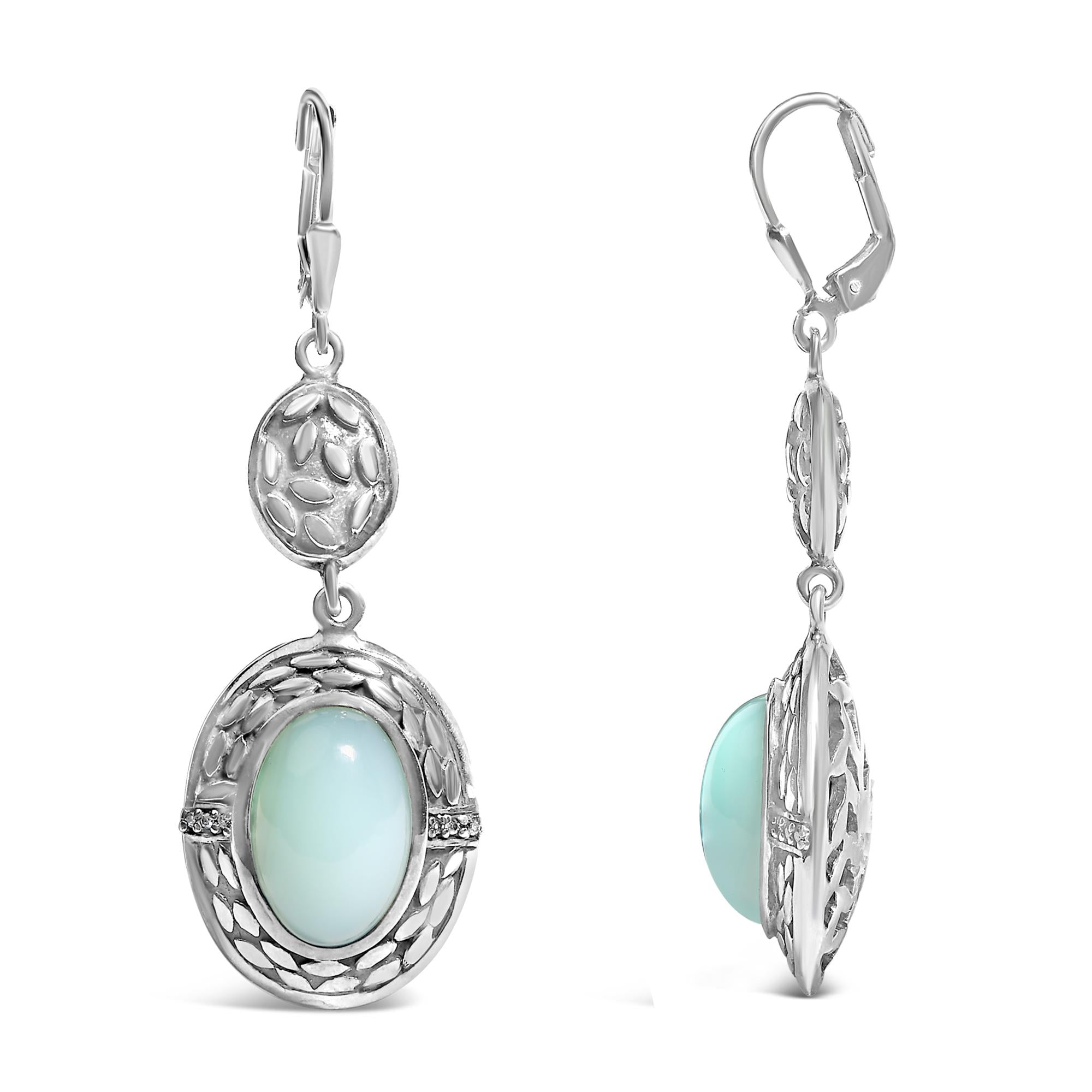 Silver earrings with light blue gemstones on a white background