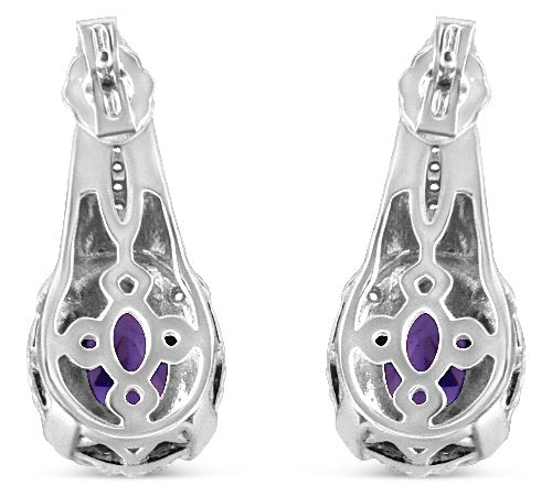 Silver earrings with purple gemstones on a white background