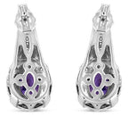 Silver earrings with purple gemstones on a white background