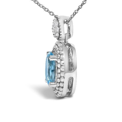 Silver pendant with blue gemstone and chain on a white background