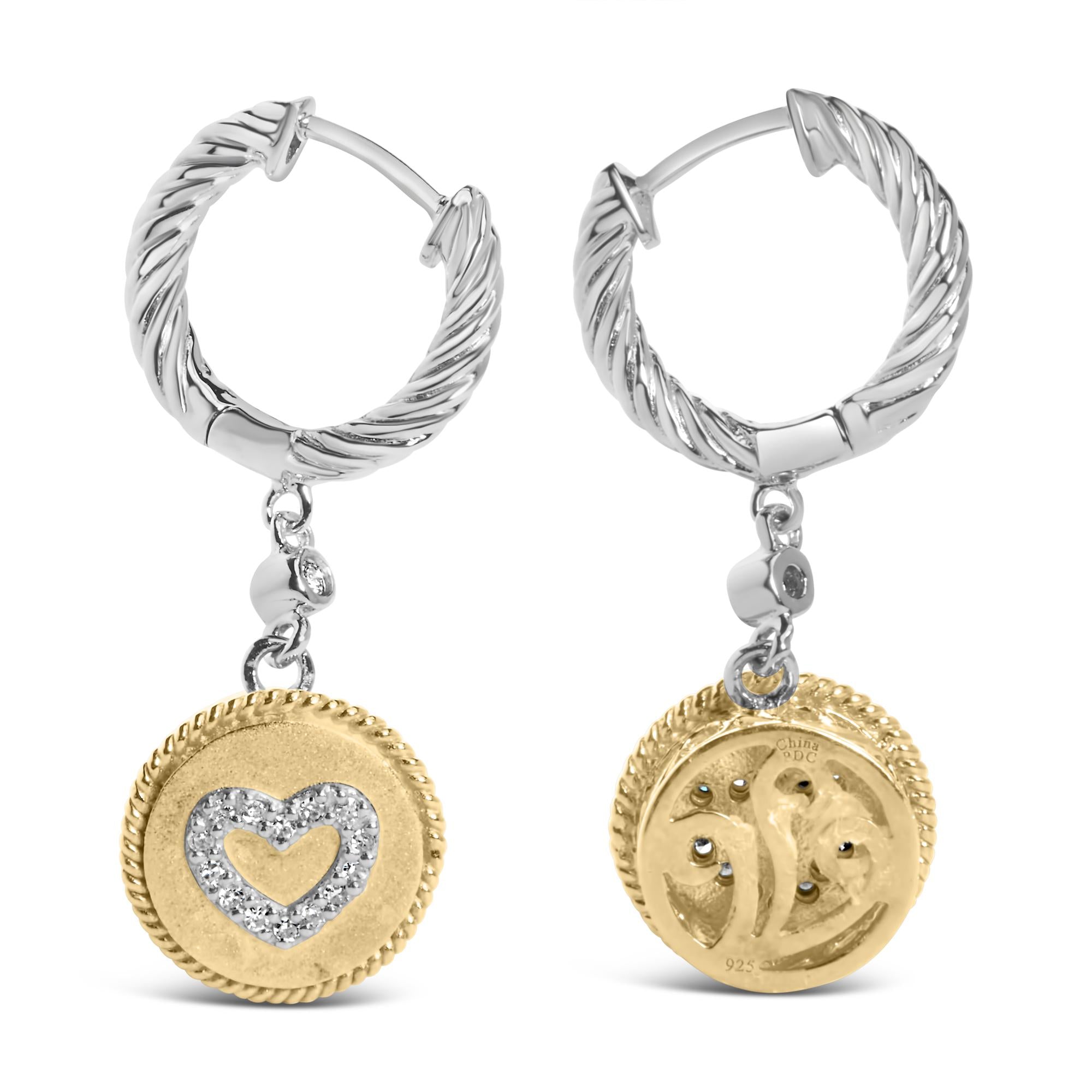 Pair of hoop earrings with gold and silver coin charms on a white background