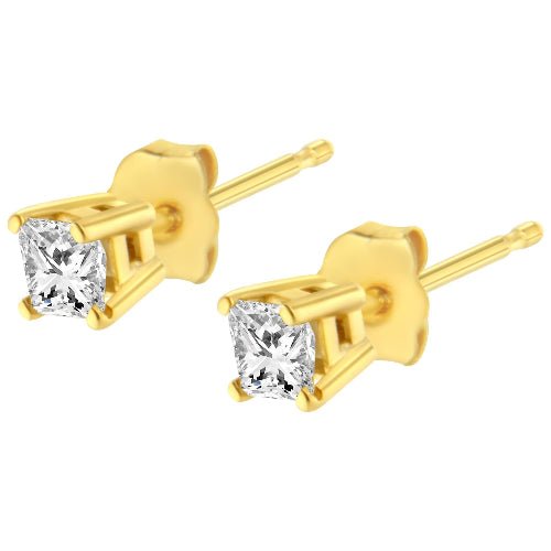 Gold stud earrings with clear gemstones on a white background