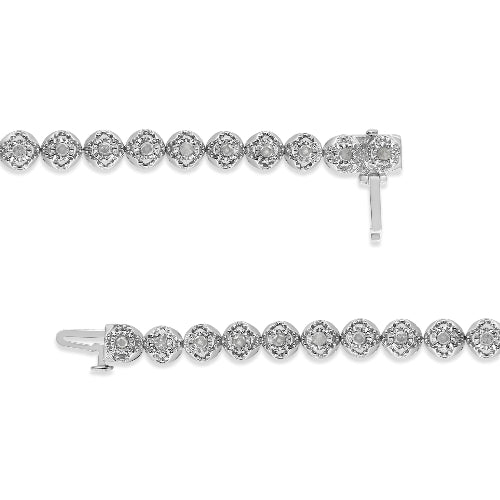 Silver bracelet and earrings set on a white background