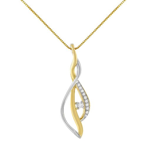 Two-tone gold and silver pendant with a diamond on a white background