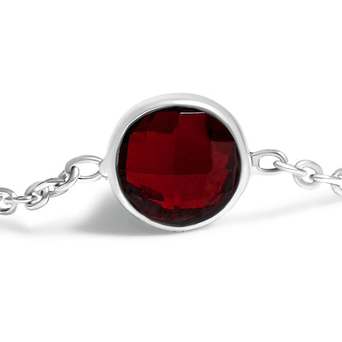 Silver bracelet with a red gemstone on a white background