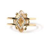 Gold ring with a large gemstone and smaller diamonds on a white background