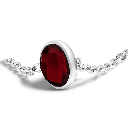 Silver necklace with a red gemstone on a white background
