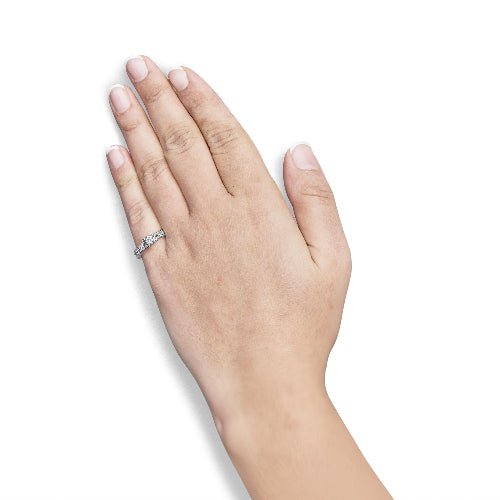 Hand wearing a silver ring on a white background