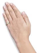 Hand wearing a gold ring with a diamond on a white background