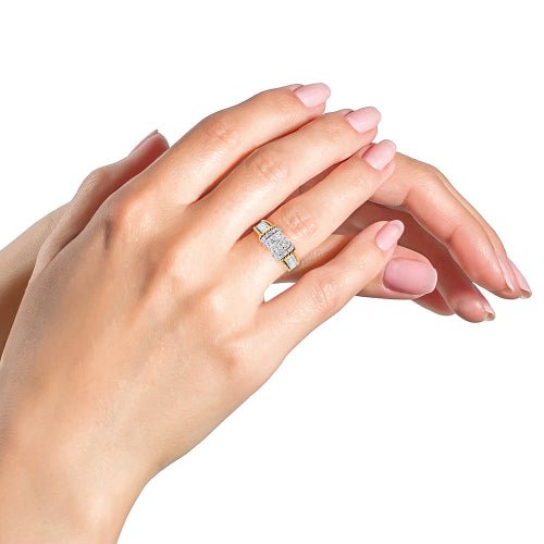 Silver ring on a hand with pink nail polish against a white background