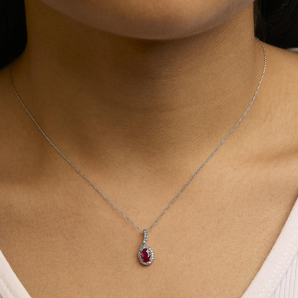 Necklace with a red gemstone pendant on a person's neck