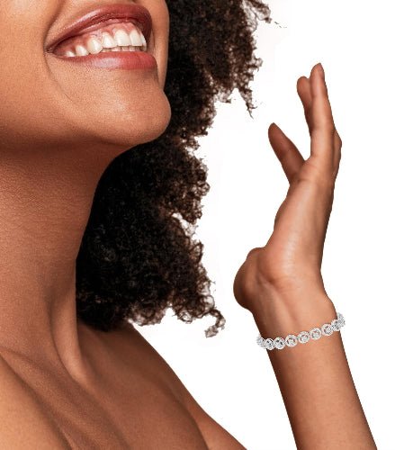 Woman wearing a silver bracelet on a white background