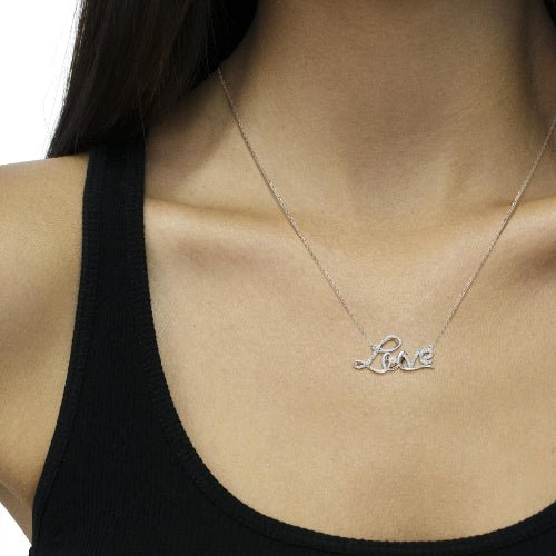 Necklace with 'Love' pendant on a person wearing a black top