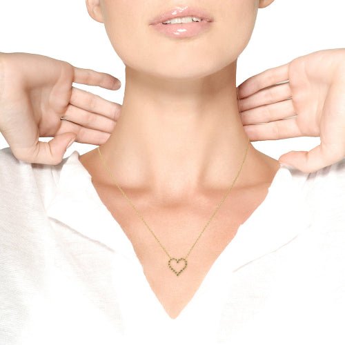 Necklace with a heart-shaped pendant being worn on a plain background