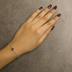 Hand with a silver bracelet on a brown background