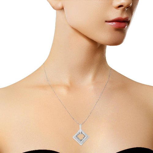 Silver necklace with a geometric pendant on a model against a white background