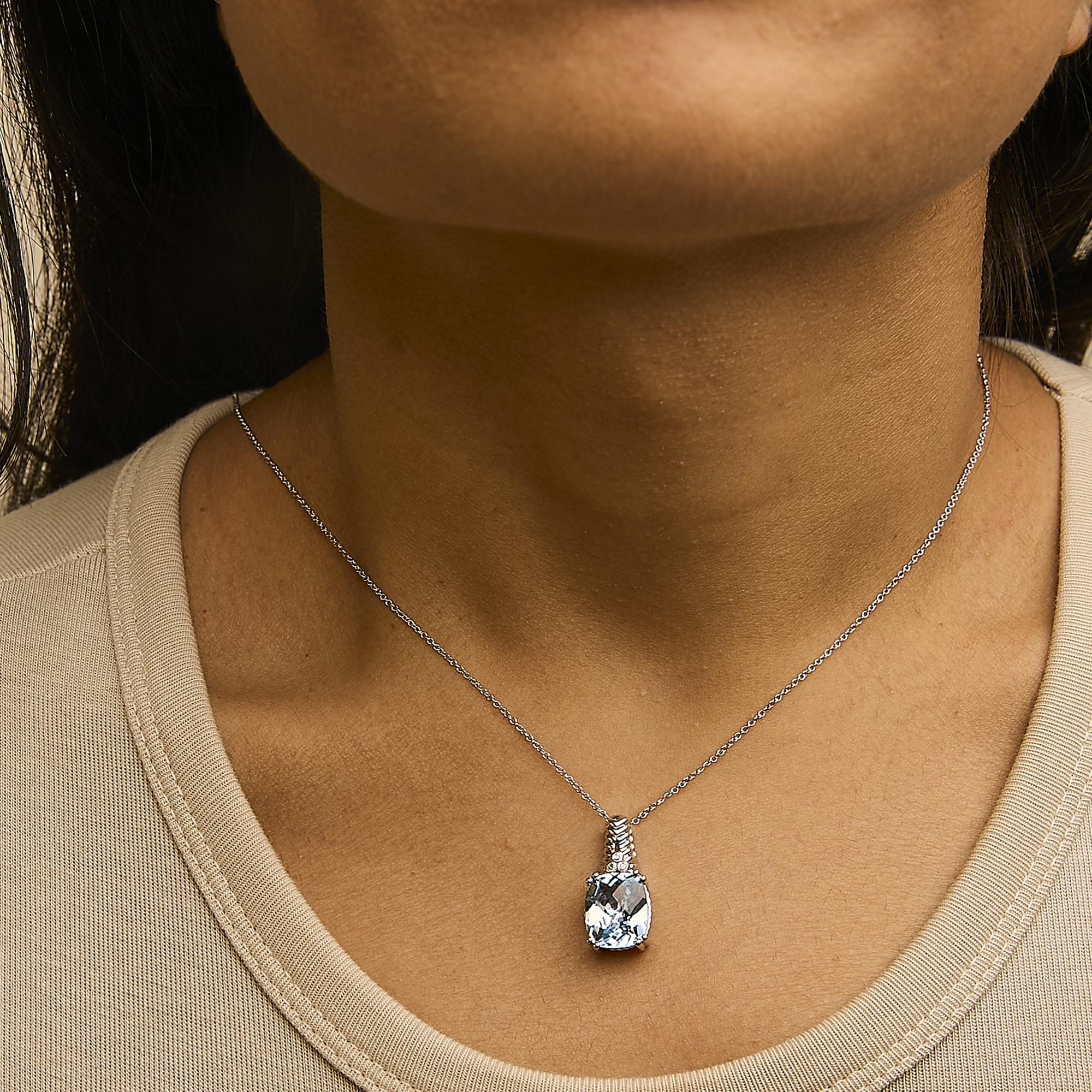 Necklace with a teardrop-shaped pendant worn by a person