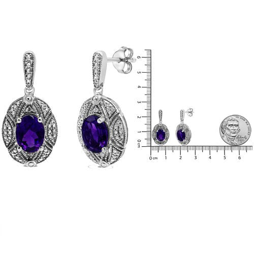 Amethyst earrings with silver setting on a white background, accompanied by a ruler for scale.