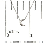 Silver crescent moon necklace on a white background with measurement scale