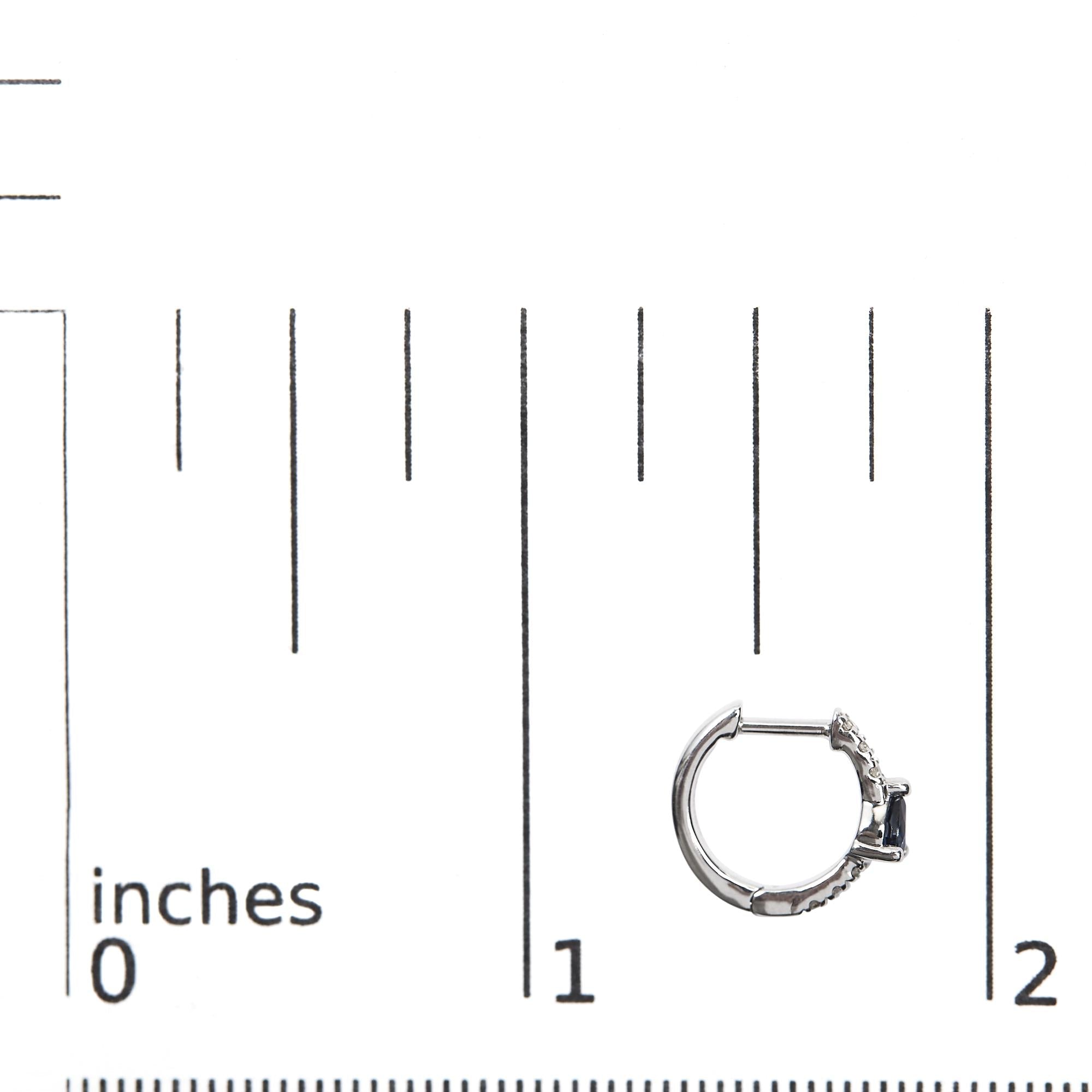 Silver hoop earring on a measurement scale from 0 to 2 inches.