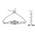 Silver bracelet with decorative elements on a white background with measurement scale.