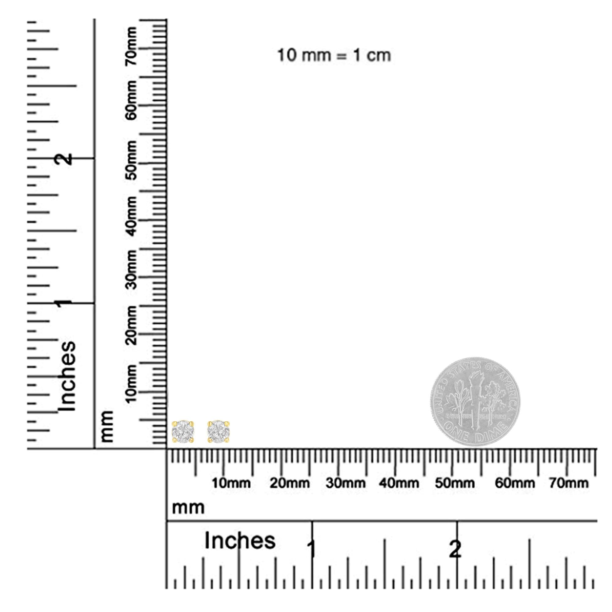 Measurement chart with ruler and two small round objects on a white background