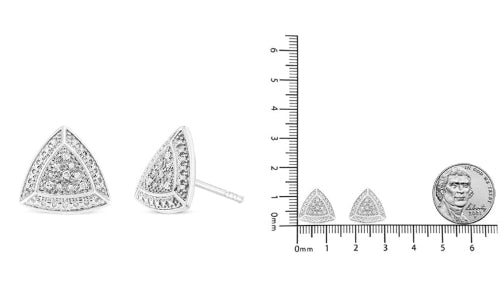 Triangular earrings with a ruler for scale on a white background
