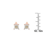 Rose gold square-cut gemstone earrings with a measurement scale on a white background