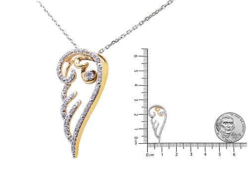 Gold and silver pendant with chain, shown with a ruler for scale on a white background