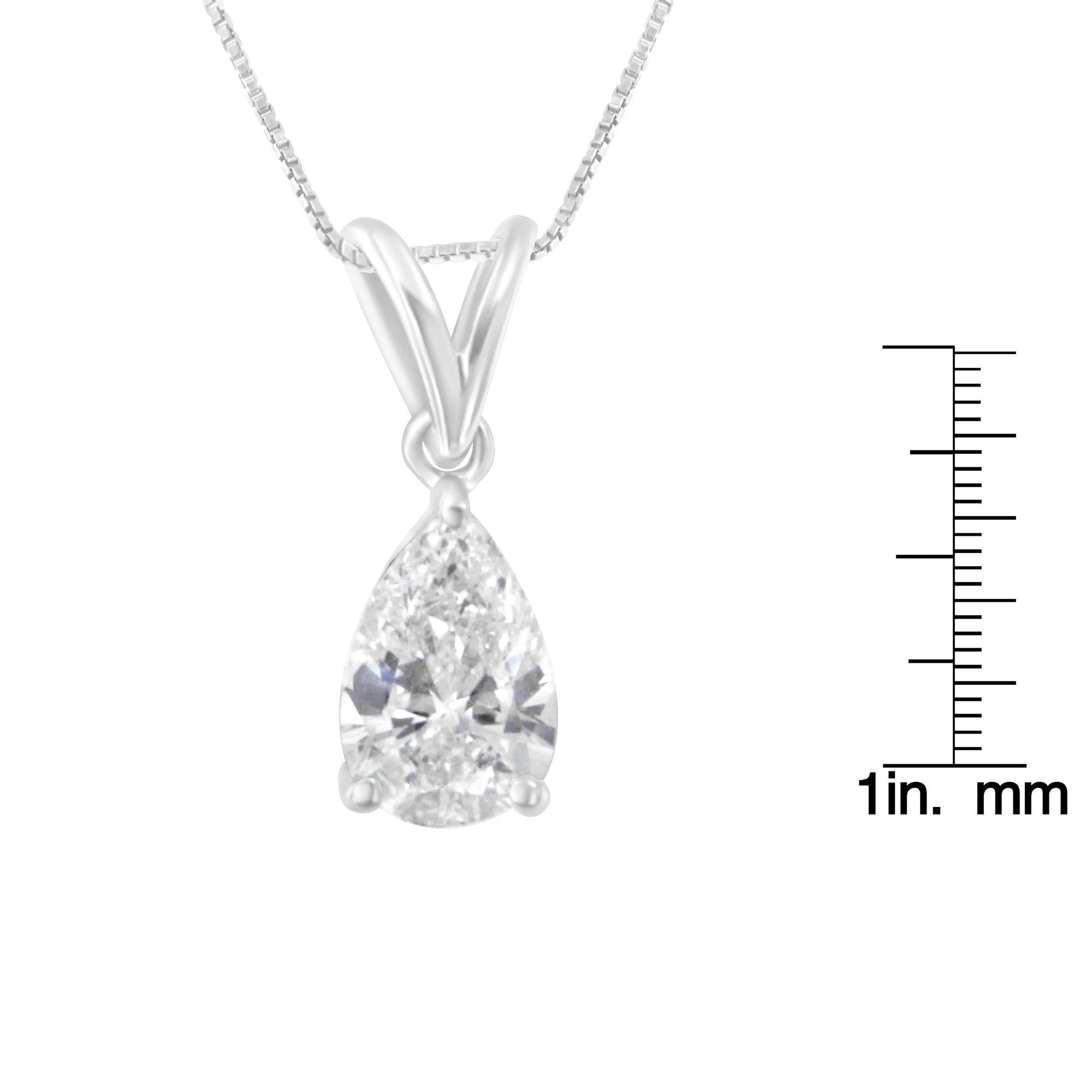 IGi certified diamond teardrop pendant on a chain with measurement scale