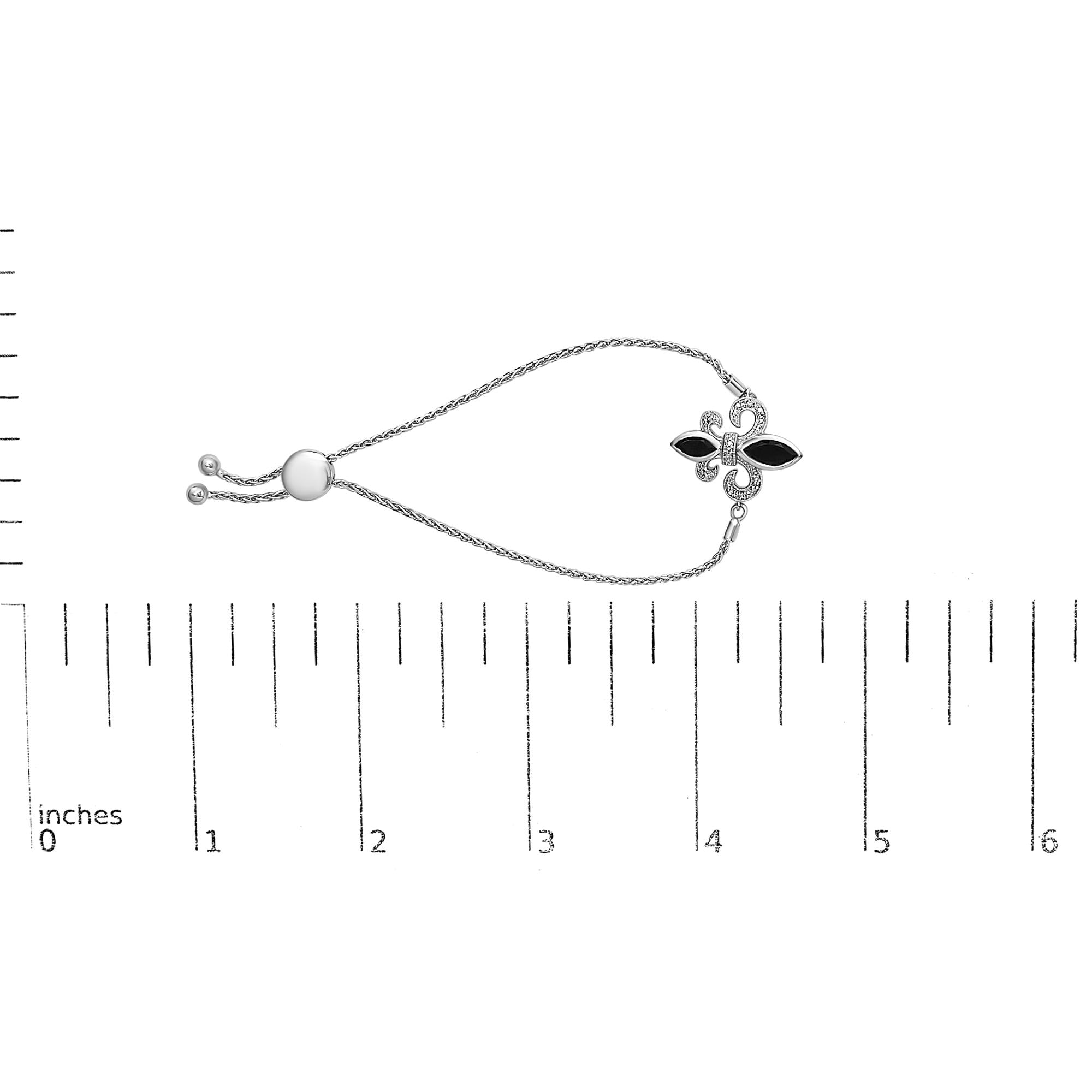 Bracelet with floral clasp and pearl on a white background with measurement scale