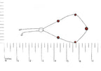 Bracelet with red beads on a white background with a ruler for scale.