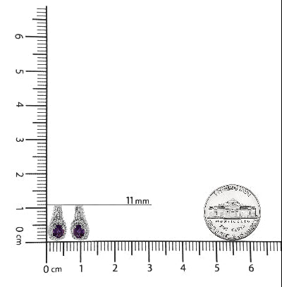 Pair of earrings with purple gemstones next to a ruler for scale on a white background.