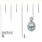 Earring with blue gemstone and diamond accents on a measurement scale