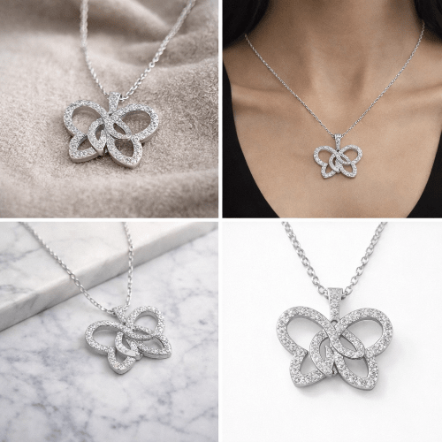 Silver butterfly necklace on a marble surface and worn by a person.