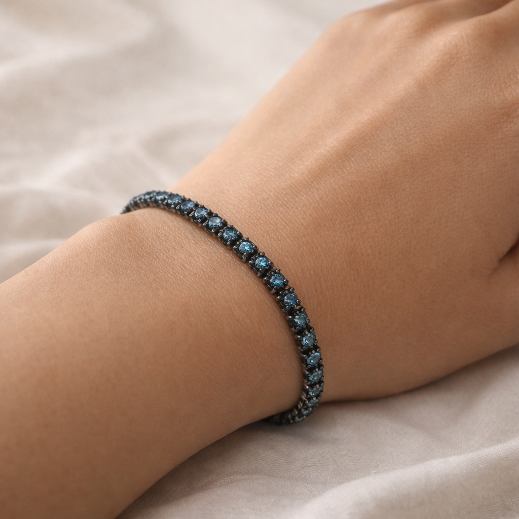 Close-up of a wrist wearing a blue beaded bracelet on a light background