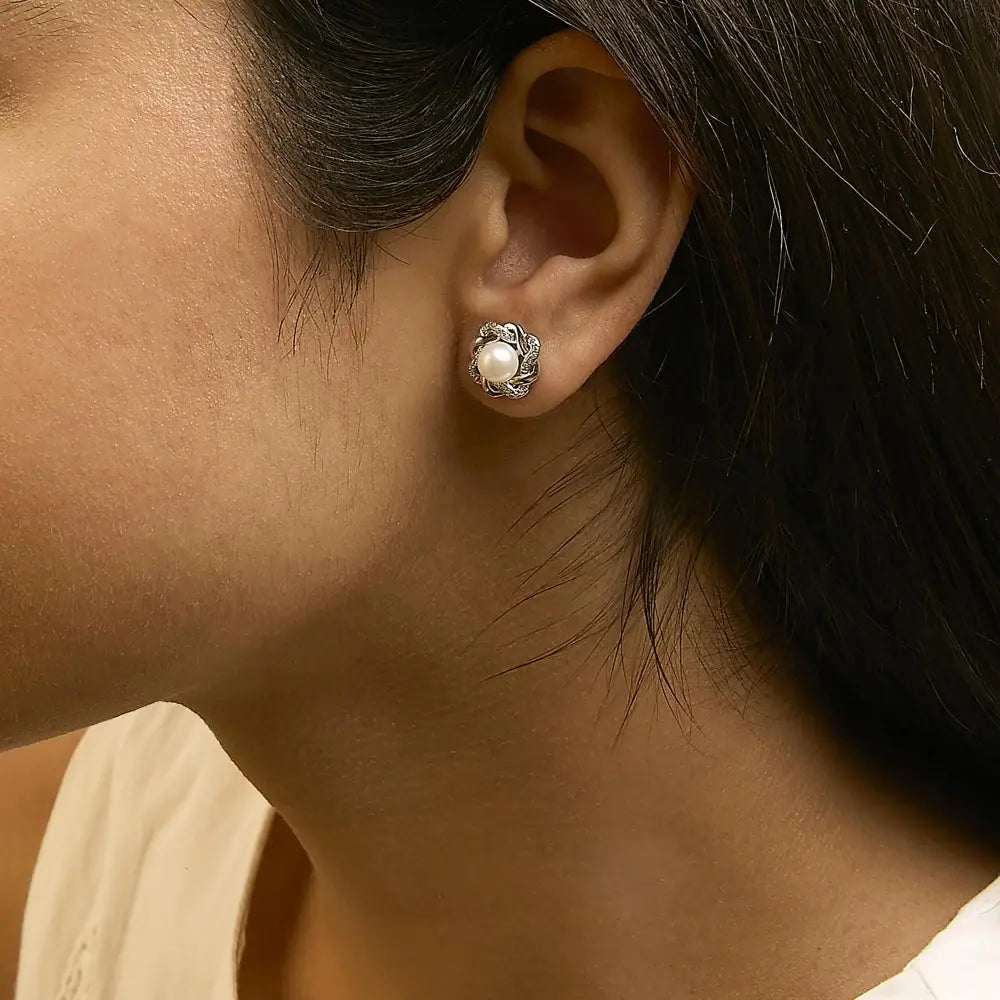 Pearl and diamond floral twist stud earrings in 925 sterling silver 0.10 cttw bijoux-nyc direct