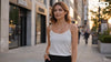 Woman wearing an elegant diamond necklace while walking through a luxury shopping district